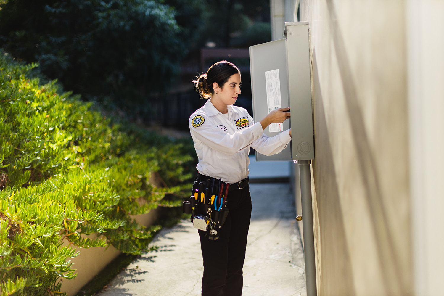A technician working on an electrical panel